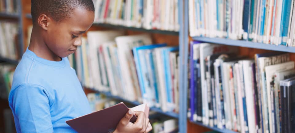 A child reading a book in a library