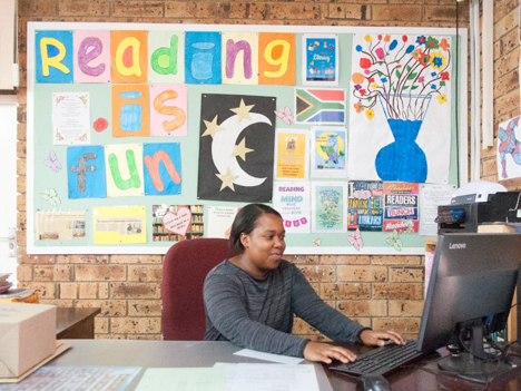 A library assistant working on her computer