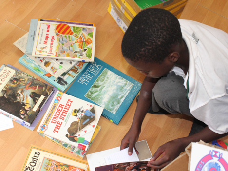 A young school child organising books